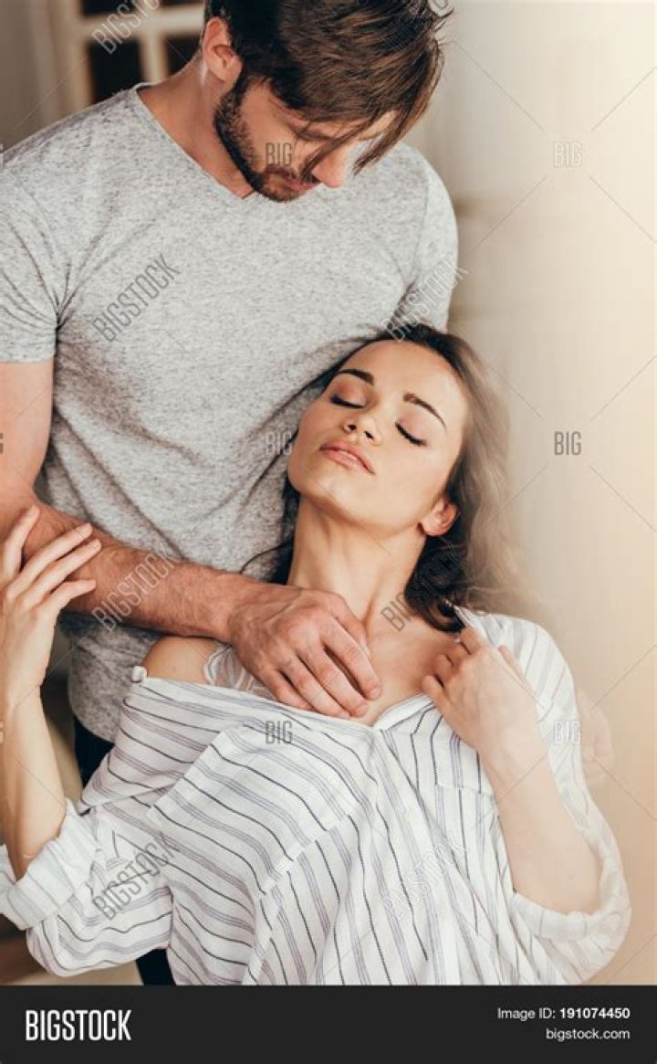 A woman is touching her tummy while holding an ultrasound photo A woman is touching her tummy while holding an ultrasound photo