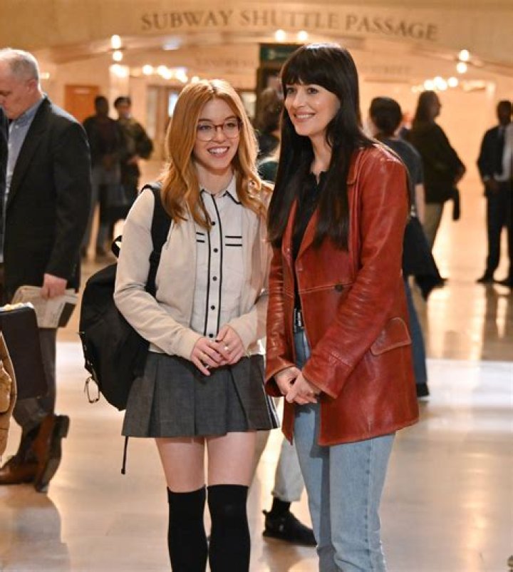 Sydney Sweeney and Dakota Johnson with Madame Web poster.